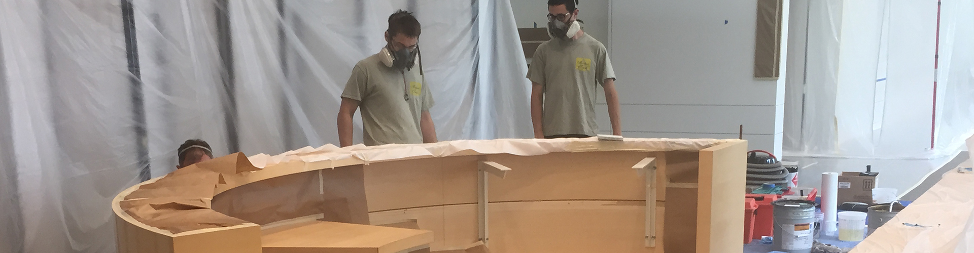 Men working on wooden furniture