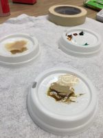 Testing different stains on coffee lids